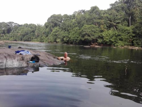 After a hard days walking in the rain forests of Liberia a wash in the Dube River is well deserved